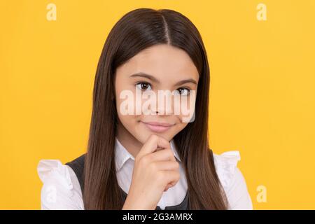 School girl child face yellow background, portrait Stock Photo