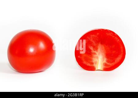 Tomatoes isolated on white background, whole and half tomatoes. Stock Photo