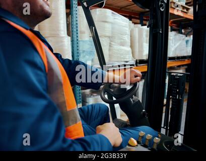 Close-up of a warehouse worker operating forklift truck Stock Photo