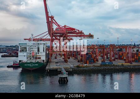 Container ship Westwood Madeira loading containers  at Port of Vancouver BC, Canada. Moored at container wharf. Stock Photo