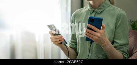 data backup - transfer information from old to new phone with cable connection. copy space Stock Photo