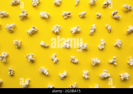 Popcorn scattered on yellow background. Popcorn pattern. top view. Stock Photo