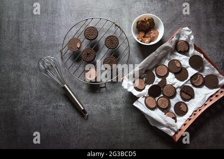 Dark chocolate biscuits with use of selective focus on a tray and grill stand Stock Photo