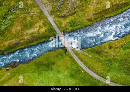 The aerial top down view of a milky blue river and a bridge, Iceland. Stock Photo