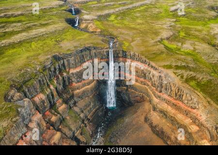 Aerial view of the Hengifoss waterfall in East Iceland. Hengifoss is the third highest waterfall in Iceland and is surrounded by basaltic strata with