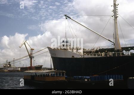 Loading Oil Drums into Foreward hold of an Oil Tanker, Curacao Stock Photo