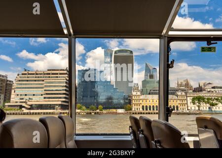 LONDON ENGLAND THAMES CYCLONE CLIPPER VIEW FROM INSIDE THE BOAT TOWARDS THE WALKIE TALKIE SKYSCRAPER Stock Photo