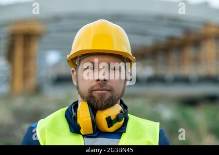 Young serious engineer or builder in hardhat and workwear Stock Photo
