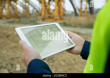 Touchpad with architectural sketch in hands of modern engineer Stock Photo