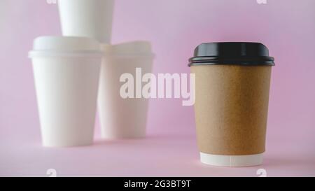 Recycle Paper Coffee Cup Mockup, Take Away Cup for Drinks Isolated on Pink Background with White Paper Coffee Cup Background. Stock Photo