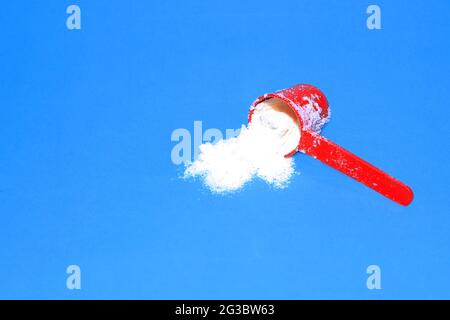 visible milk powder spilling from the spoon Stock Photo