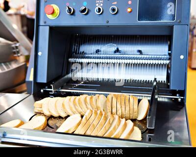 Sliced white bread in a cutting machine Stock Photo