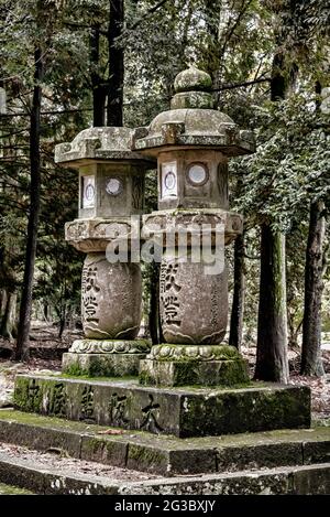 Ishidoro, stone japanese lanterns along the paths of Nara Park, Nara, Japan. Stock Photo