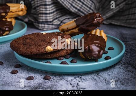 Dark chocolate coated digestive biscuit with chocolate cookies and chips for loved ones valentines day celebration. Partially eaten with crumbs. side Stock Photo
