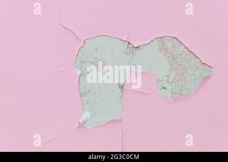 Peeling paint and plaster from the wall. Bloated paint and plaster Stock Photo