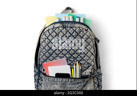 Flat lay top view backpack with different colorful stationery on white table Stock Photo