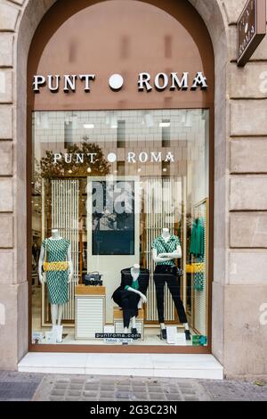 Barcelona, Spain - May 11, 2021. Logo and facade of Punt Roma, clothing store Stock Photo