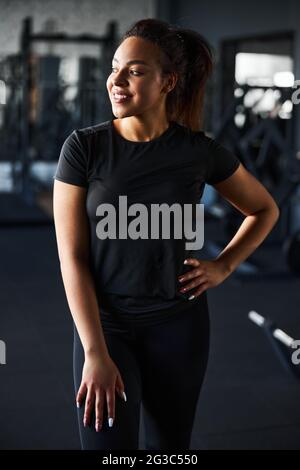 Cheerful young woman having fun in gym Stock Photo