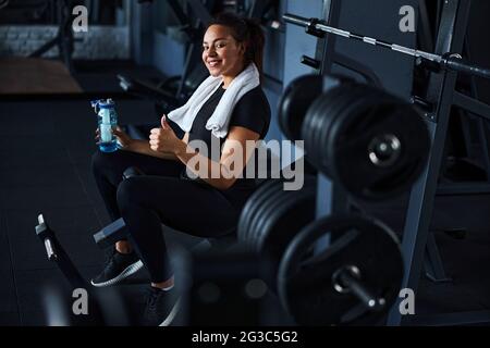 Smiling pretty woman feeling happy after gym workout Stock Photo