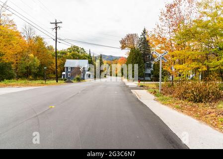 Railroad crossing in a small town in the mountains on a cloudy autumn day Stock Photo