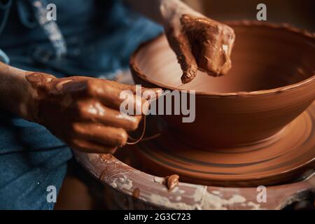 Image of process creating texture on pottery wheel in workshop Stock Photo
