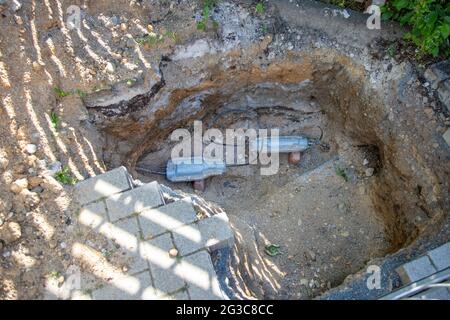construction site, hole in the ground with an underground cable connector Stock Photo