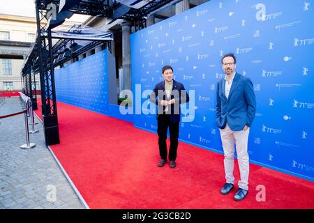 Berlin, Germany. 15th June, 2021. Ryusuke Hamaguchi (l), director, and Carlo Chatrian, artistic director of the Berlinale, arrive for the premiere of the film 'Guzen to sozo' (Wheel of Fortune and Fantasy) at the open-air cinema on Museum Island. Credit: Christoph Soeder/dpa-Pool/dpa/Alamy Live News Stock Photo