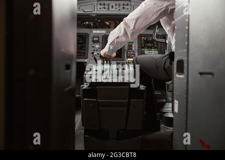 Pilot use steering to fly on passenger airplane Stock Photo