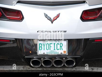 a license plate with a message 'BYOFFICER' on a Corvette parked on a street in Ogunquit, Maine, USA Stock Photo