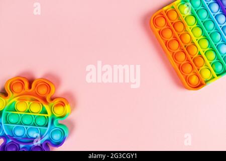 Anti-stress toys pop it, simple dimple, on pink background, copy space. Concept trendy entertainment for fidget children, sensory toys for development Stock Photo