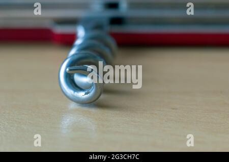 Extreme Macro selective focus of corkscrew of wine cork attached to army knife. Shallow depth of field. Stock Photo