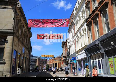 Banners for social justice, sustainability, the environment etc on the High Street in Coventry, UK City of Culture 2021, in Warwickshire, UK Stock Photo