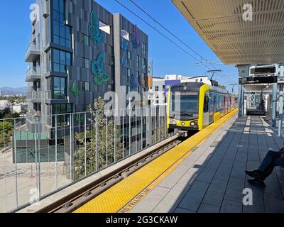 A Metro Rail train arrives at the Culver City station near new apartment buildings in Los Angeles, CA Stock Photo