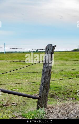 Barbed wire around a wooden fence Stock Photo - Alamy