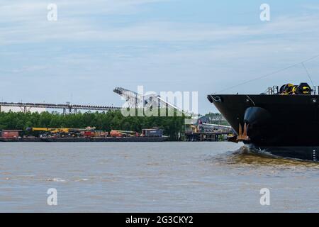 NEW ORLEANS, LA, USA - MAY 28, 2021: Bow of Cargo Ship on the Mississippi River with grain elevator across the river in the background Stock Photo