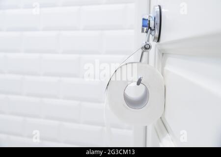 toilet paper roll hanging in bathroom close up Stock Photo