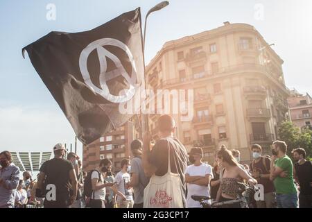 Barcelona, Spain. 15th June, 2021. A protester waving an anarchist flag, during the demonstration.Organized by the Platform for People Affected by Mortgages (PAH) and housing unions of Barcelona, Some 300 people demonstrated against evictions, after the death of a 58-year-old man who committed suicide when he was going to be evicted. (Photo by Thiago Prudencio/SOPA Images/Sipa USA) Credit: Sipa USA/Alamy Live News Stock Photo