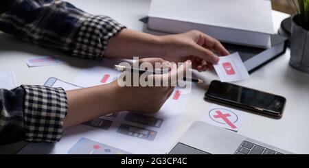 A close-up of an ux ui developer and an ui designer working on a mockup icon interface for a mobile app. Stock Photo