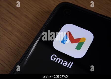 Gmail app seen on the corner of smartphone placed on the desk. Stafford, United Kingdom, June 15, 2021. Stock Photo