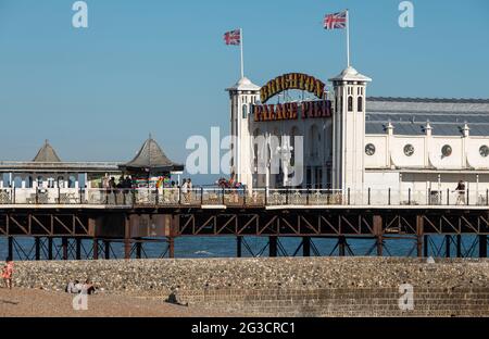 Entrance to Palace Pier on the Brighton, East Sussex UK sea front, showing illuminated neon sign.