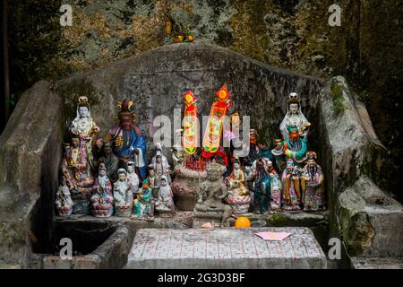 A small shrine to the pantheon of locally-worshipped gods in a village street on Peng Chai, one of the Outlying Islands of Hong Kong Stock Photo