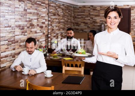 Female waiter showing country restaurant Stock Photo