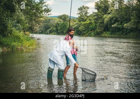 Male hobby. Fishing freshwater lake pond river. Keep calm and fish on. Weekends made for fishing. Trout bait. Activity and hobby. Men fishing on the Stock Photo