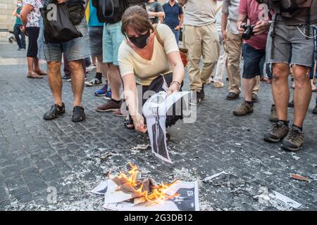 Elisenda Paluzie, president of the Catalan National Assembly (ANC), is seen burning photos of the Spanish king, Felipe VI, during the demonstration.The Catalan association that aims at achieving the political independence of Catalonia, the Catalan National Assembly (ANC), has called a demonstration against the visit to Catalonia of the Spanish King, Felipe VI, to attend the inaugural dinner of the XXXVI Meeting of the Barcelona business organization, Circulo de Economia (Economy Circle). The demonstration was attended by the president of the ANC, Elisenda Paluzie, who participated in the burni Stock Photo
