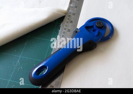 On the mat for patchwork sewing there are  knife for patchwork, a ruler, Stock Photo