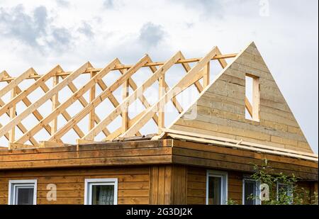 Construction new triangular roof of a wooden house in the village Stock Photo