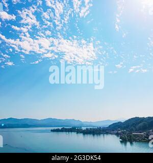 Idyllic Swiss landscape, view of lake Zurich in Wollerau, canton of Schwyz in Switzerland, Zurichsee, mountains, blue water, sky as summer nature and Stock Photo