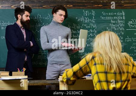 University studying friends studying and reading a books in classroom. Teachers reputation is gold. Students build positive relationships with their Stock Photo