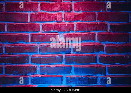 Brick wall texture background in red and blue neon lights Stock Photo