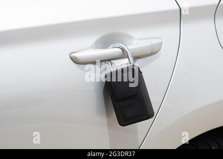 Close-up of portable padlock key safe security box attached to a car door handle containing car or house keys while surfing Stock Photo